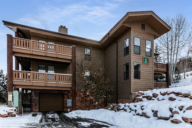 8050 Gambel Dr Unit O-1, Park City, UT 84098 - view of front of house featuring a balcony, a chimney, and a garage