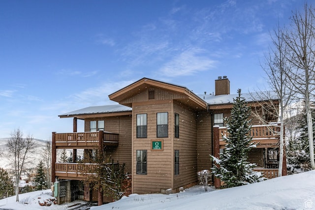 8050 Gambel Dr Unit O-1, Park City, UT 84098 - view of snow covered exterior with a balcony and a chimney