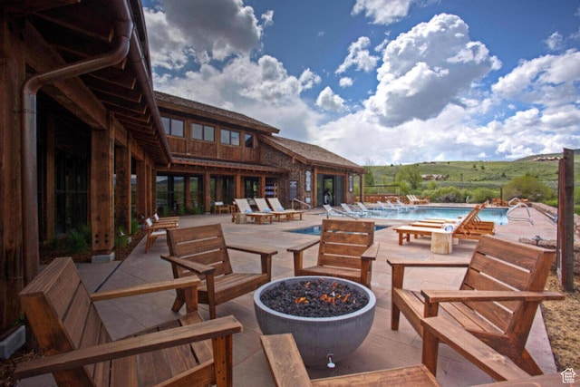 7394 E Moon Light Dr Unit 326A, Heber City, UT 84032 - view of patio / terrace featuring a community pool and a fire pit