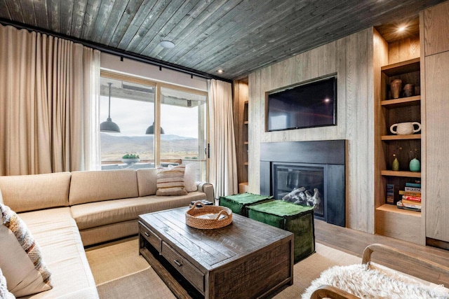 7394 E Moon Light Dr Unit 326A, Heber City, UT 84032 - living area featuring built in shelves, a large fireplace, wooden ceiling, and wood walls