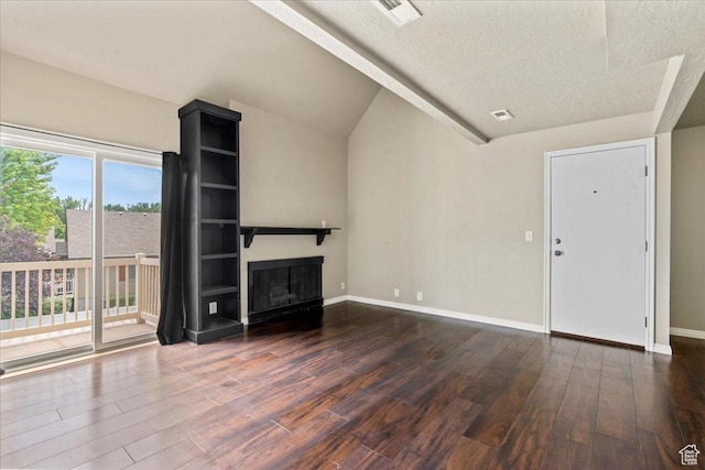88 W 50 S Unit C9, Centerville, UT 84014 - unfurnished living room with wood finished floors, a textured ceiling, a glass covered fireplace, and vaulted ceiling