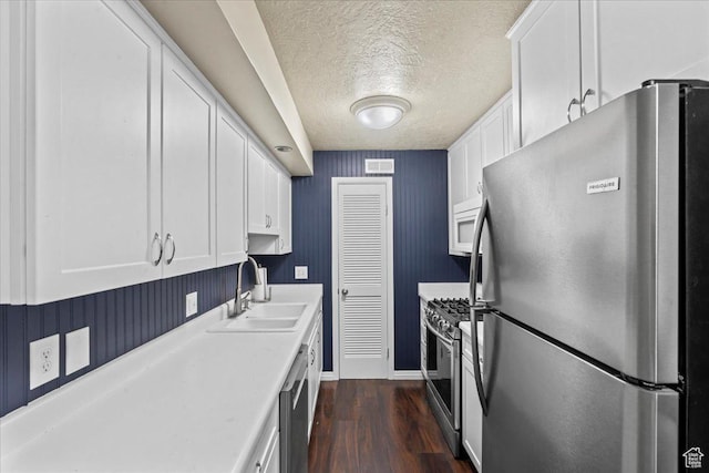 88 W 50 S Unit C9, Centerville, UT 84014 - kitchen featuring stainless steel appliances, a textured ceiling, white cabinets, light countertops, and dark wood-style floors