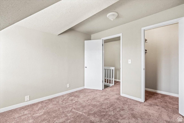 88 W 50 S Unit C9, Centerville, UT 84014 - unfurnished bedroom featuring carpet floors and a walk in closet