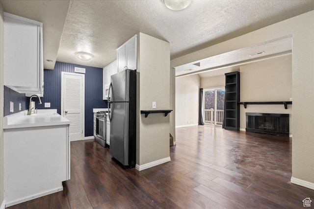 88 W 50 S Unit C9, Centerville, UT 84014 - kitchen featuring appliances with stainless steel finishes, a textured ceiling, white cabinets, dark wood-type flooring, and light countertops