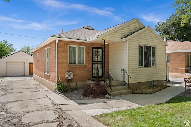 817 N Catherine St, Salt Lake City, UT 84116 - view of front of property featuring an outbuilding, driveway, a garage, roof with shingles, and brick siding
