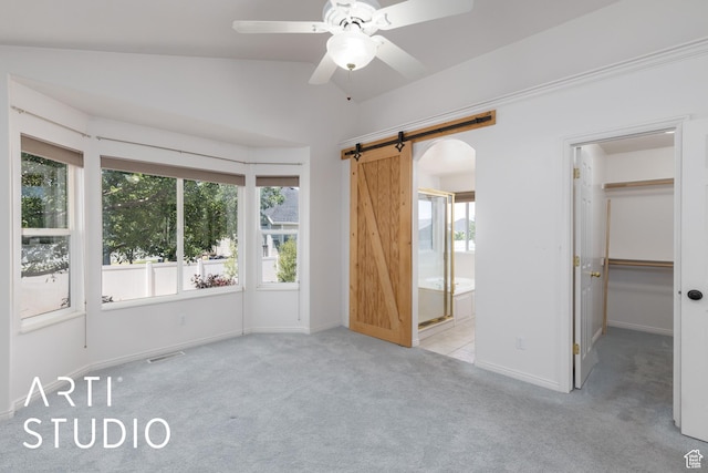 1209 N 1120 W, Clinton, UT 84015 - unfurnished bedroom featuring carpet flooring, multiple windows, a barn door, a walk in closet, and lofted ceiling