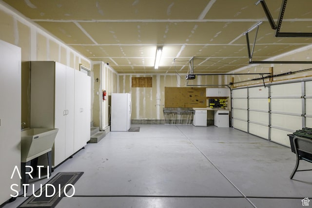 1209 N 1120 W, Clinton, UT 84015 - garage featuring freestanding refrigerator and a garage door opener