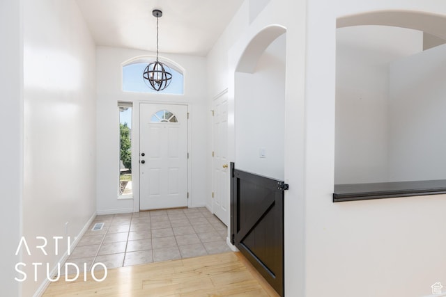 1209 N 1120 W, Clinton, UT 84015 - foyer featuring a chandelier, light wood-style floors, and arched walkways