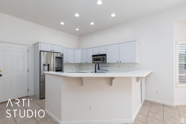 1209 N 1120 W, Clinton, UT 84015 - kitchen with appliances with stainless steel finishes, light tile patterned floors, a breakfast bar area, light countertops, and recessed lighting