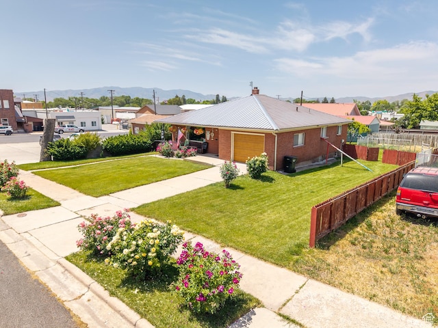 115 N Main St, Malad City, ID 83252 - ranch-style house with a mountain view, an attached garage, a metal roof, brick siding, and a chimney