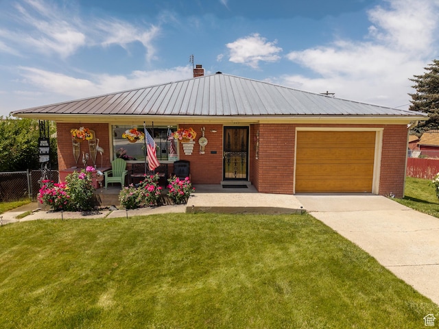 115 N Main St, Malad City, ID 83252 - view of front facade with a garage, brick siding, driveway, a chimney, and covered porch
