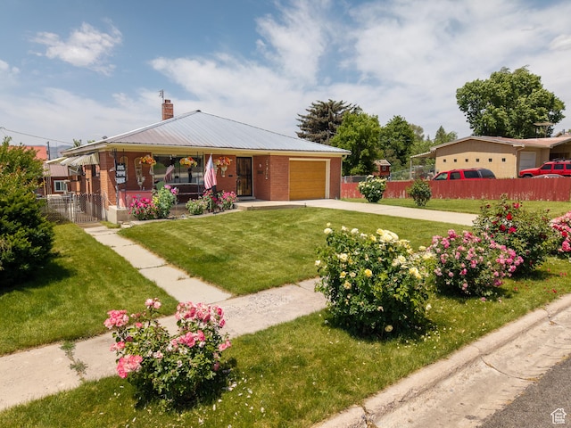 115 N Main St, Malad City, ID 83252 - view of front of property with covered porch, driveway, an attached garage, a chimney, and brick siding
