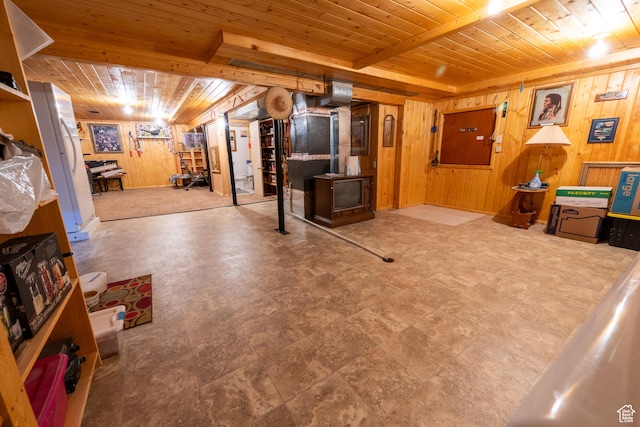 115 N Main St, Malad City, ID 83252 - finished basement with wood ceiling, wood walls, a wood stove, and tile patterned floors