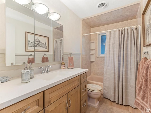 3645 E Fortuna Cir, Salt Lake City, UT 84124 - full bathroom featuring vanity, shower / bath combo with shower curtain, wood finished floors, wainscoting, and tile walls