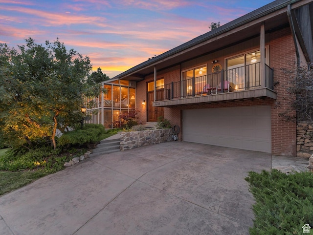 3645 E Fortuna Cir, Salt Lake City, UT 84124 - view of front property with brick siding, an attached garage, concrete driveway, and a balcony
