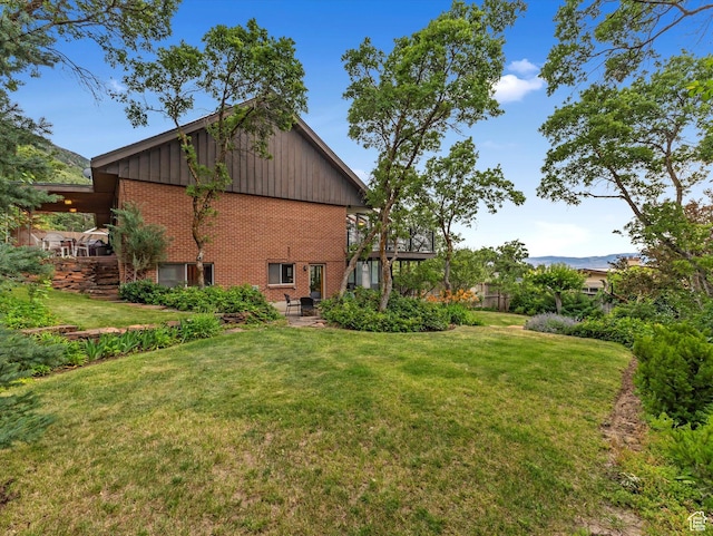 3645 E Fortuna Cir, Salt Lake City, UT 84124 - view of property exterior featuring brick siding, board and batten siding, and a lawn