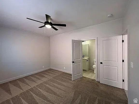 840 N Twin Lakes Dr Unit 414, St George, UT 84790 - unfurnished bedroom with carpet floors, ensuite bathroom, and a ceiling fan