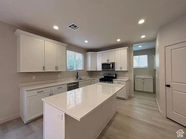 840 N Twin Lakes Dr Unit 414, St George, UT 84790 - kitchen featuring appliances with stainless steel finishes, healthy amount of natural light, light countertops, white cabinets, and recessed lighting
