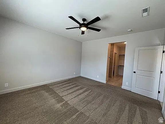 840 N Twin Lakes Dr Unit 414, St George, UT 84790 - unfurnished bedroom with carpet floors, a spacious closet, and ceiling fan