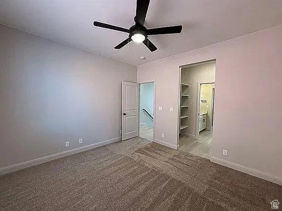 840 N Twin Lakes Dr Unit 414, St George, UT 84790 - unfurnished bedroom featuring carpet floors, ceiling fan, and ensuite bathroom