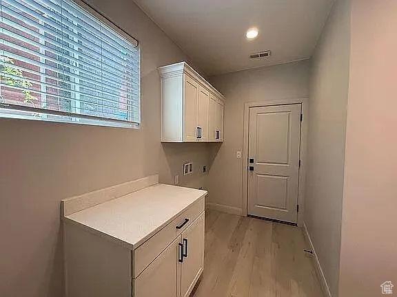 840 N Twin Lakes Dr Unit 414, St George, UT 84790 - laundry room featuring cabinet space, light wood-style floors, and washer hookup