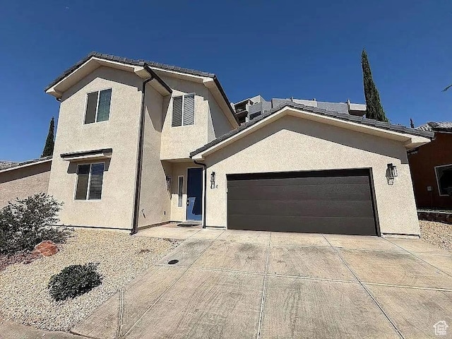 840 N Twin Lakes Dr Unit 414, St George, UT 84790 - view of front of home featuring stucco siding, concrete driveway, and an attached garage