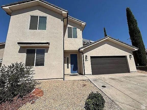 840 N Twin Lakes Dr Unit 414, St George, UT 84790 - view of front of house featuring stucco siding, a garage, and concrete driveway