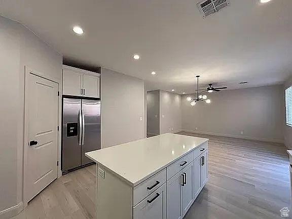 840 N Twin Lakes Dr Unit 414, St George, UT 84790 - kitchen featuring built in refrigerator, recessed lighting, a kitchen island, light countertops, and white cabinets