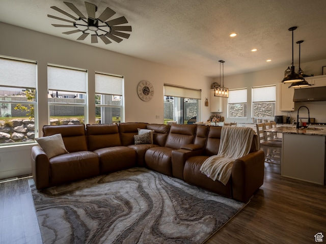 4821 W Juniper Bend Cir Unit 101, Herriman, UT 84096 - living room with a ceiling fan, dark wood-style floors, recessed lighting, and a textured ceiling