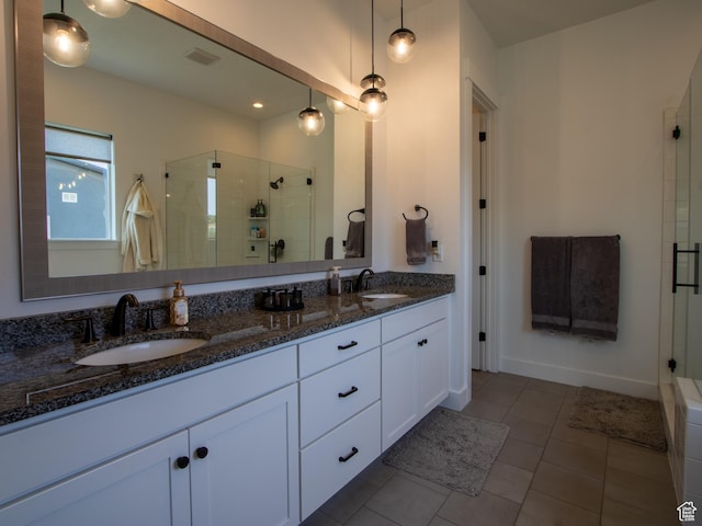 4821 W Juniper Bend Cir Unit 101, Herriman, UT 84096 - full bath with a stall shower, double vanity, and tile patterned flooring