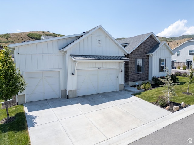 4821 W Juniper Bend Cir Unit 101, Herriman, UT 84096 - modern inspired farmhouse featuring board and batten siding, a standing seam roof, driveway, a garage, and a metal roof