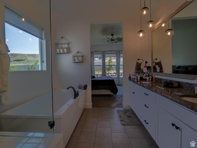 4821 W Juniper Bend Cir Unit 101, Herriman, UT 84096 - bathroom with ceiling fan, double vanity, a bath, tile patterned flooring, and ensuite bath