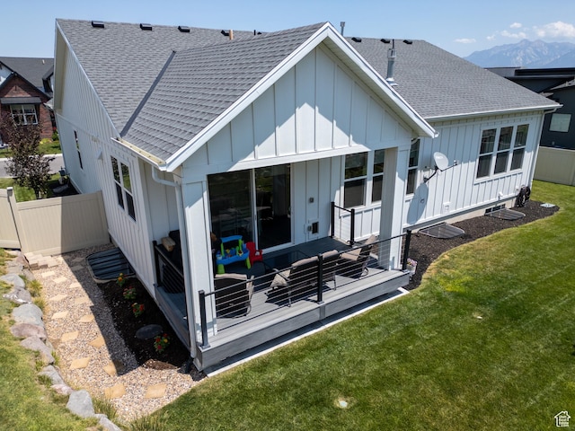 4821 W Juniper Bend Cir Unit 101, Herriman, UT 84096 - rear view of house with board and batten siding, a shingled roof, a wooden deck, and an outdoor hangout area