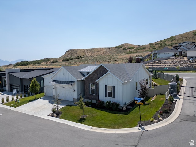 4821 W Juniper Bend Cir Unit 101, Herriman, UT 84096 - modern farmhouse with board and batten siding, driveway, a garage, and a mountain view