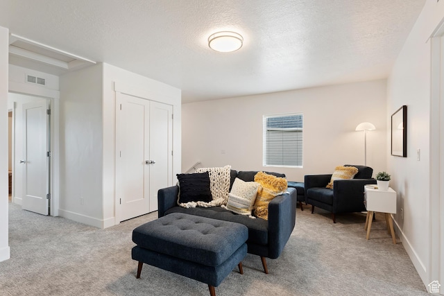 1695 W 2770 S Unit 203, Syracuse, UT 84075 - living room featuring light colored carpet and a textured ceiling