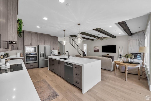 385 E Entrada Dr, Virgin, UT 84779 - kitchen featuring appliances with stainless steel finishes, light countertops, a ceiling fan, beam ceiling, and light wood finished floors