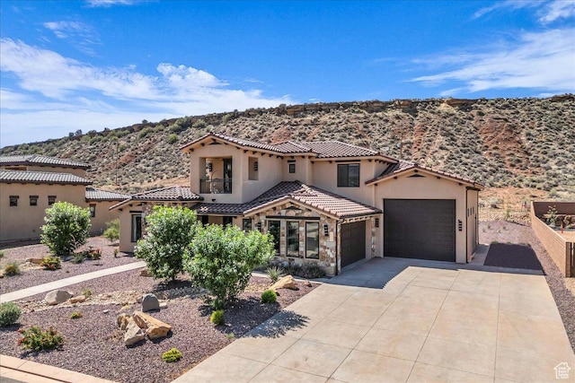 385 E Entrada Dr, Virgin, UT 84779 - mediterranean / spanish-style home with stucco siding, an attached garage, a mountain view, concrete driveway, and a tile roof