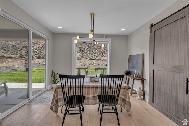 385 E Entrada Dr, Virgin, UT 84779 - dining space featuring light wood-type flooring, a barn door, a chandelier, and recessed lighting