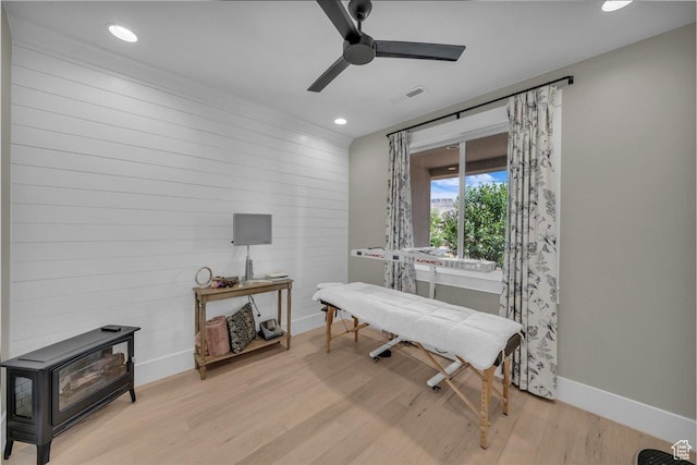 385 E Entrada Dr, Virgin, UT 84779 - sitting room with wood finished floors, a wood stove, ceiling fan, recessed lighting, and wooden walls