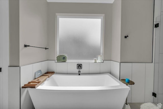 385 E Entrada Dr, Virgin, UT 84779 - bathroom with a freestanding tub, tile walls, and wainscoting