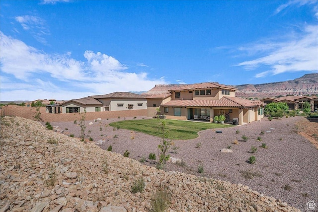 385 E Entrada Dr, Virgin, UT 84779 - rear view of property featuring a tiled roof, stucco siding, a garage, and a mountain view