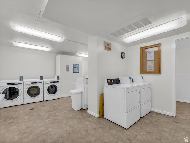 777 E S Temple Unit 5A, Salt Lake City, UT 84102 - community laundry room featuring washing machine and dryer and light tile patterned floors