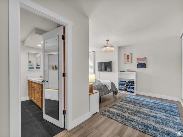777 E S Temple Unit 5A, Salt Lake City, UT 84102 - bedroom with a chandelier, dark wood-style flooring, and ensuite bath