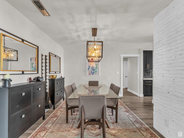 777 E S Temple Unit 5A, Salt Lake City, UT 84102 - dining space with a chandelier and wood finished floors