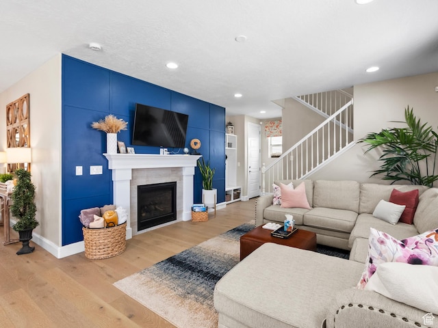 6412 W Chan Reese Dr, West Jordan, UT 84081 - living room featuring light wood-style floors, stairway, recessed lighting, and a tiled fireplace