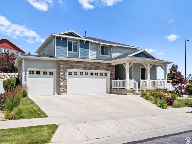 6412 W Chan Reese Dr, West Jordan, UT 84081 - view of front facade with a porch, driveway, a garage, and stone siding