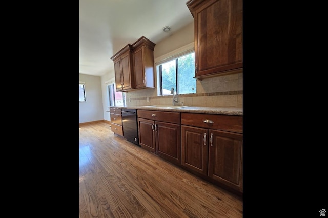 638 E 1050 N, Bountiful, UT 84010 - kitchen with black dishwasher, light wood-style floors, light countertops, decorative backsplash, and healthy amount of natural light