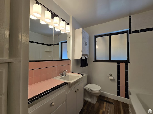 638 E 1050 N, Bountiful, UT 84010 - bathroom featuring wood finished floors, decorative backsplash, vanity, a shower, and a tub to relax in
