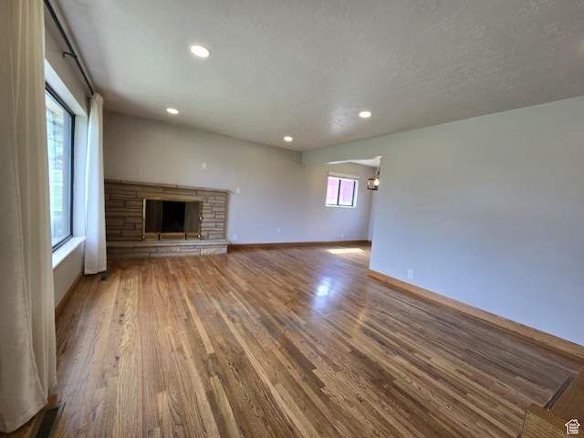 638 E 1050 N, Bountiful, UT 84010 - unfurnished living room with wood finished floors, a fireplace, and recessed lighting