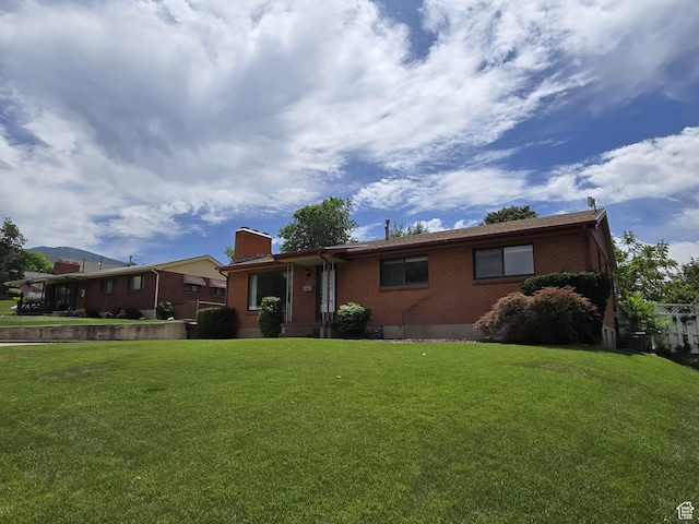 638 E 1050 N, Bountiful, UT 84010 - view of front of property featuring brick siding, a front lawn, and a chimney
